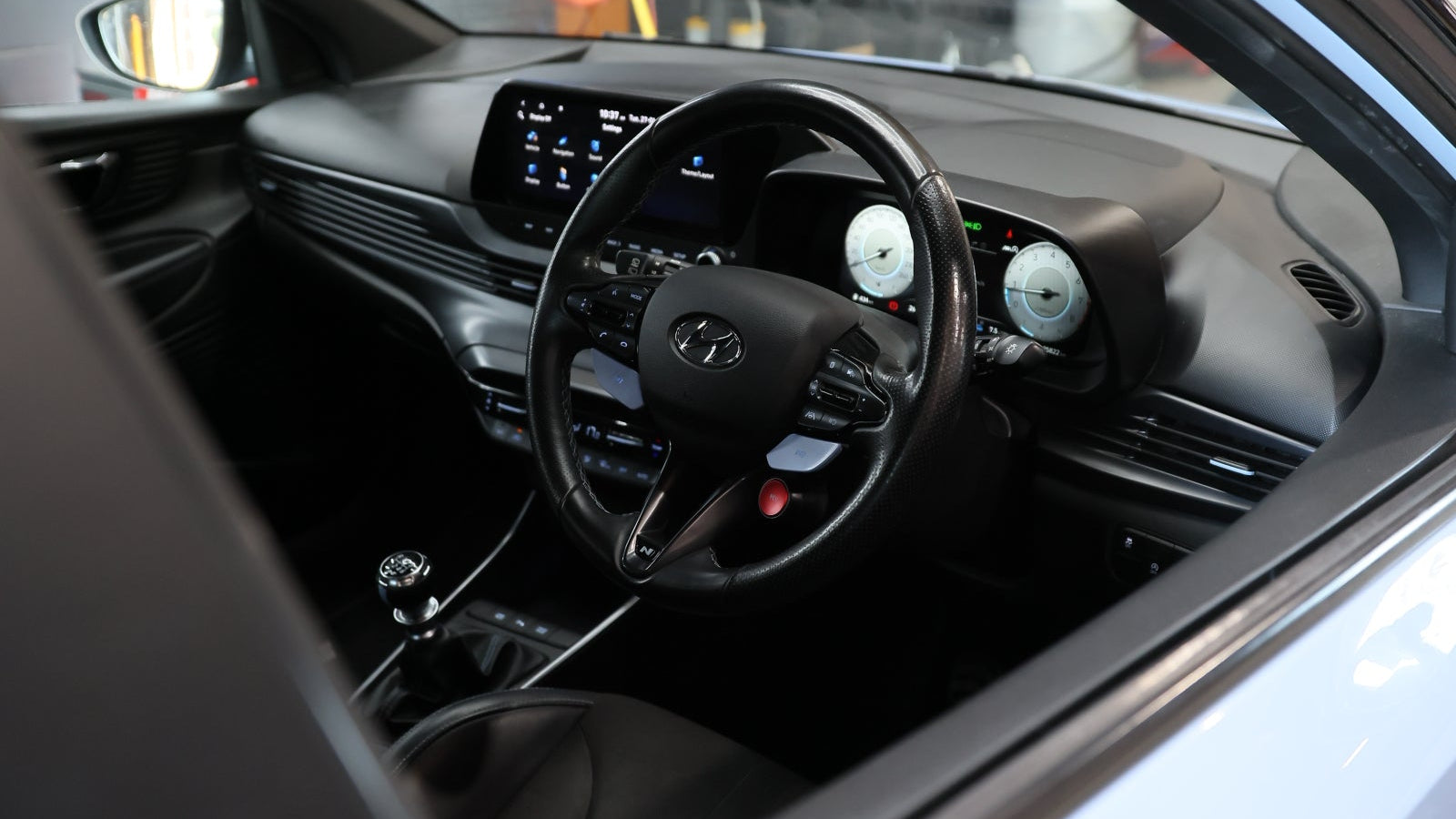 Close-up of a car interior with steering wheel and dashboard.